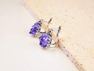 Oval Raw Amethyst earrings featuring natural purple crystals in a detailed sterling silver frame, shot on a clean background