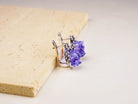 Side profile of the oval amethyst dangles, showing the depth of the raw crystal and the ornate silver setting