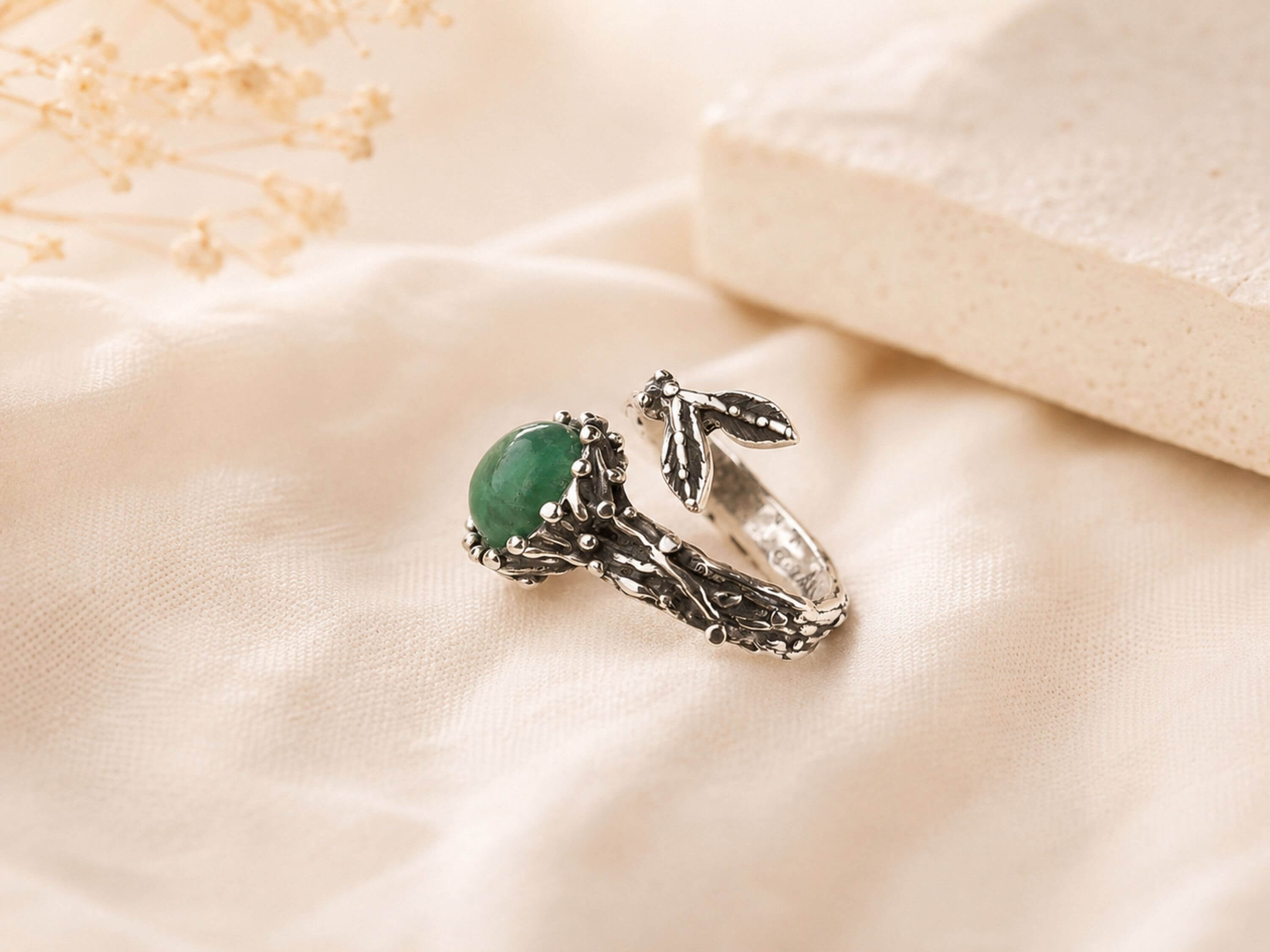 Extreme close-up of the natural Jade gemstone, highlighting the raw unpolished surface and rich green color variations.