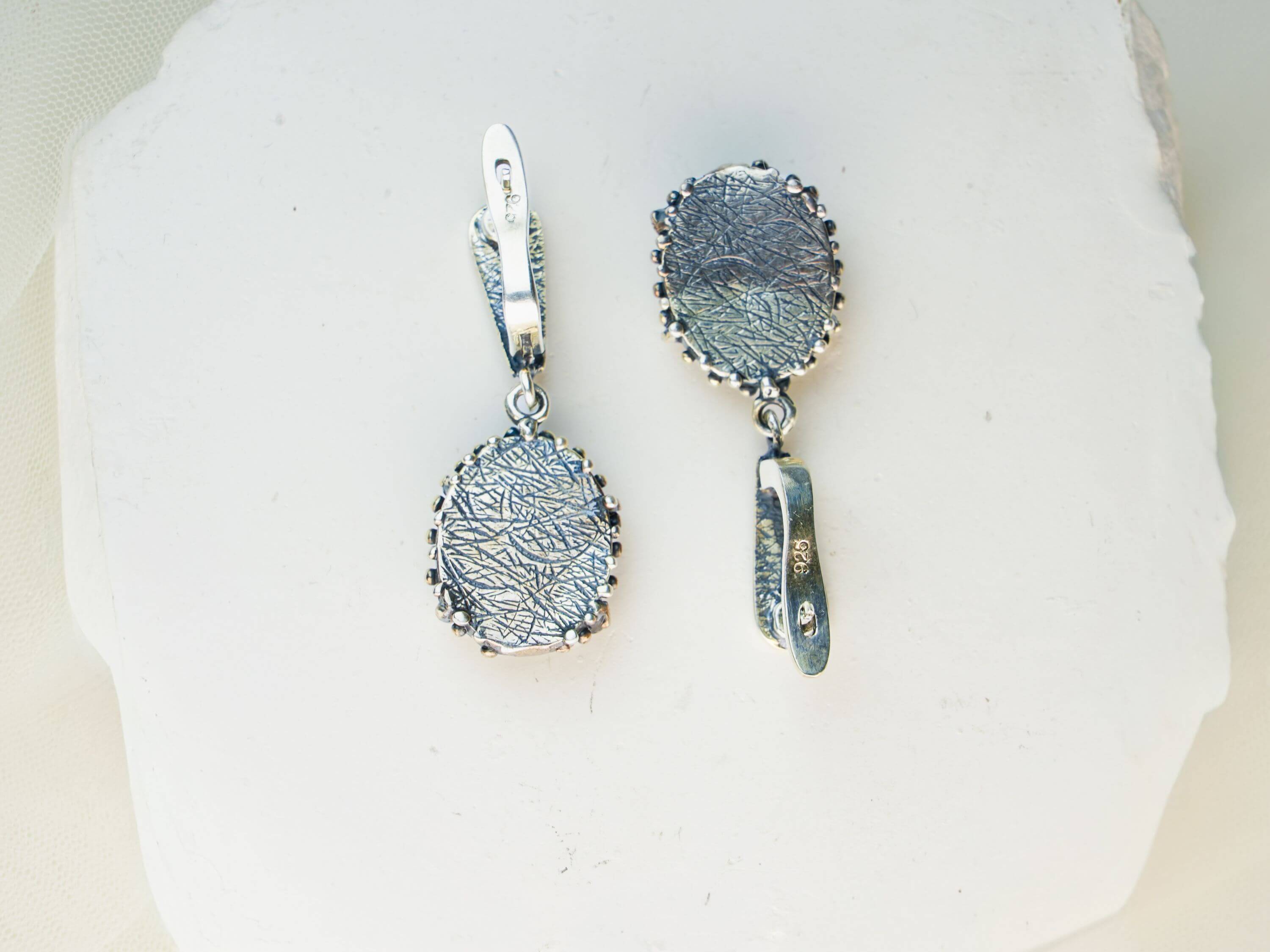 Detailed view of the secure sterling silver earring closure and polished back finish of Akra jewelry