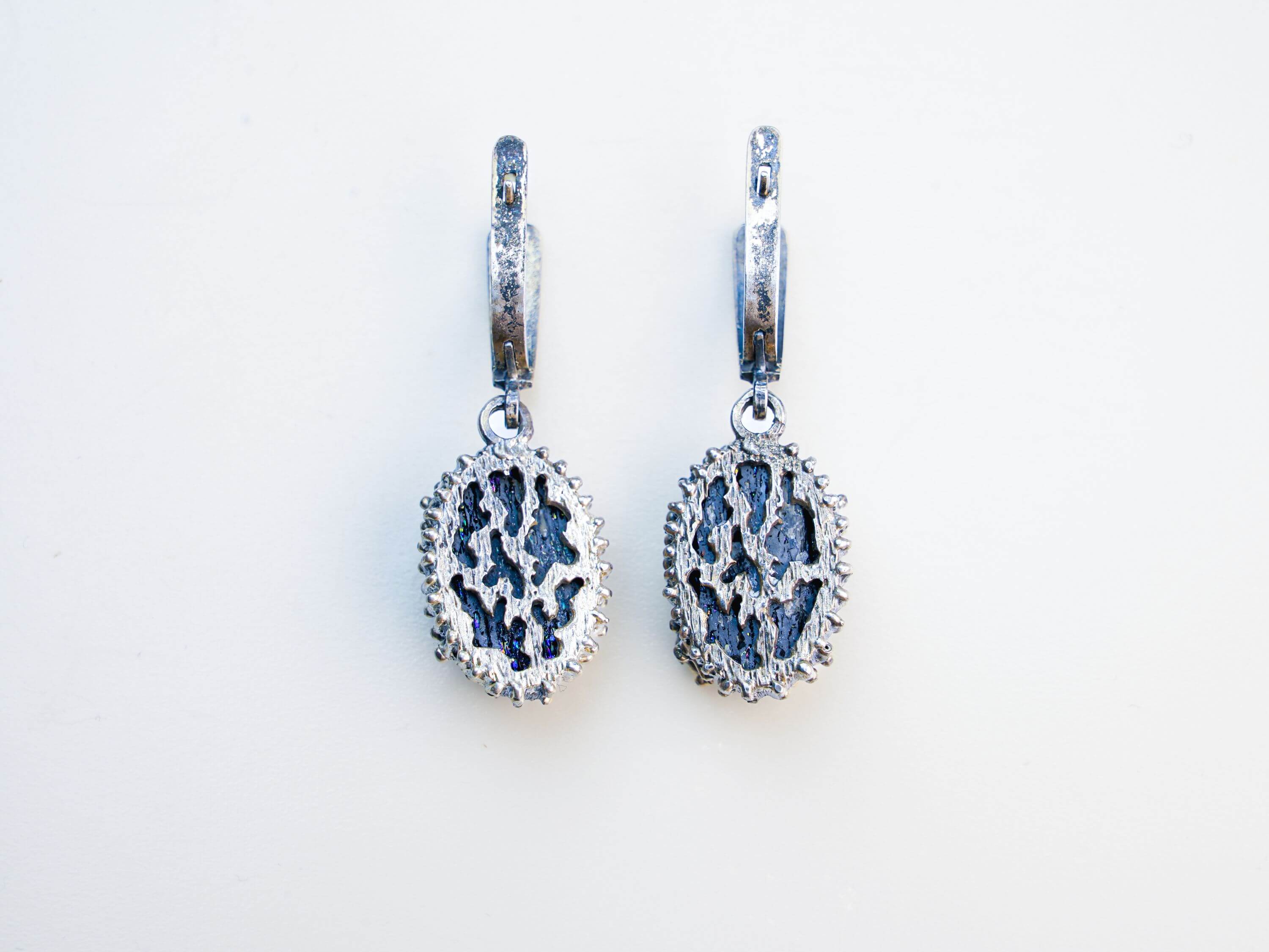 Detailed view of the back of the earring, highlighting the secure sterling silver leverback closure and artisan craftsmanship
