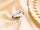 A top-down view of the white Moonstone ring on a soft silk-like background, emphasizing its sophisticated and earthy design.